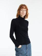 A lady wears a sheath sweater.